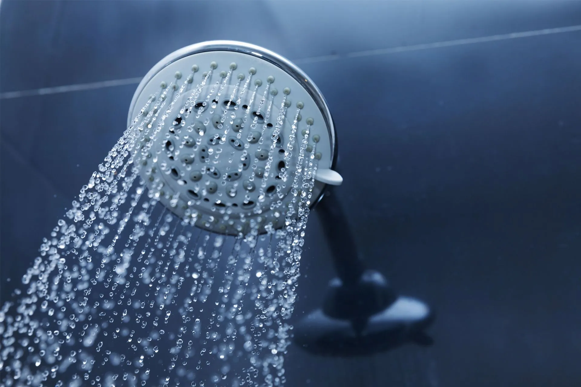 Shower head spraying water at steady household pressure